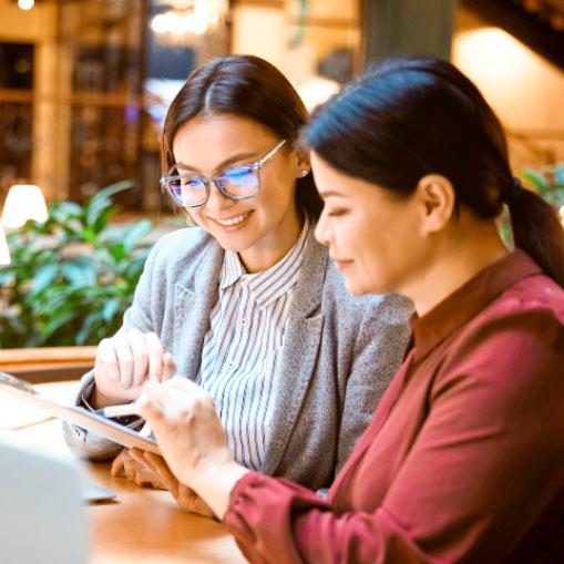 duas mulheres trabalhando com tablet